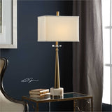 This tapered steel base is finished in a plated antiqued brass, paired with an ivory marble foot with brown veining and a crystal accent. The rectangle hardback shade is an ivory linen fabric.