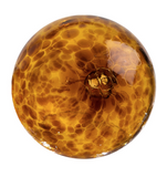 Glass round wall art colored in browns, ambers, leopard, and dark brown