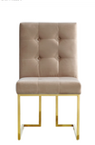 The Quaid Dining Chair has a Hollywood glam look that will take your dining area to another level. Pair this chair with the Quaid Dining Table to complete the look. A boxy geometric shape makes this chair an uber modern addition to your space, while a base of stainless steel makes it durable and tough, so it holds up to heavy daily use. The gold tone finish on the base contrasts nicely with the velvet upholstery used on the seat and back. Heavy tufting adds to the rich appeal of this beautiful design.