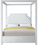 The Tailored Canopy Bed features a velvet-clad canopy that beckons you to rest like royalty. The deeply detailed tufting on the scalloped headboard makes for a sumptuous presentation, and the chrome nail heads add to the luxe look of this exquisite bed.