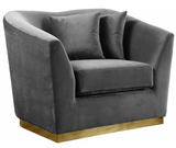 The Slope Modern Accent Chair is graceful and stylish. This handsome sofa is upholstered in velvet for a glamorous touch and is accented with gold stainless steel around its base for a touch of modernity. Its curvy back gives it a graceful look in your living room or den, and it comes with coordinating throw pillows that beckon you to sit down and rest (or nap) for a spell.