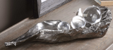 The metallic pod sculpture with attract your guest attention. This gorgeous sculpture simulates peas sitting on an open pod, finished in a tarnished, metallic silver with clear crystal spheres.