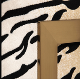 The Chitara Accent chair is bold and stylish. Featuring a chic tiger print fabric, this fashionable lounge chair boasts lived-in comfort with loose down wrapped box cushions in a plush chenille, suspended in an iron wrap-around frame finished in brushed brass. Seat height is 19".
