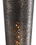 The Iron Flute Lamp can be used as a table or floor accent lamp. This heavy iron design is finished in an acid oxidized dark bronze, covered in imperfect laser cut perforations, paired with a coordinating cubed foot and crystal accent. 60 watt, T30 antique style bulb included.