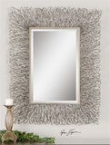 this decorative mirror features a hand forged metal frame with a silver finish and light champagne highlights