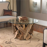 The Le Bois Cocktail table is natural, unfinished teak driftwood sculpted into a sturdy table with a clear glass top.