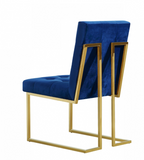 The Quaid Dining Chair has a Hollywood glam look that will take your dining area to another level. Pair this chair with the Quaid Dining Table to complete the look. A boxy geometric shape makes this chair an uber modern addition to your space, while a base of stainless steel makes it durable and tough, so it holds up to heavy daily use. The gold tone finish on the base contrasts nicely with the velvet upholstery used on the seat and back. Heavy tufting adds to the rich appeal of this beautiful design.