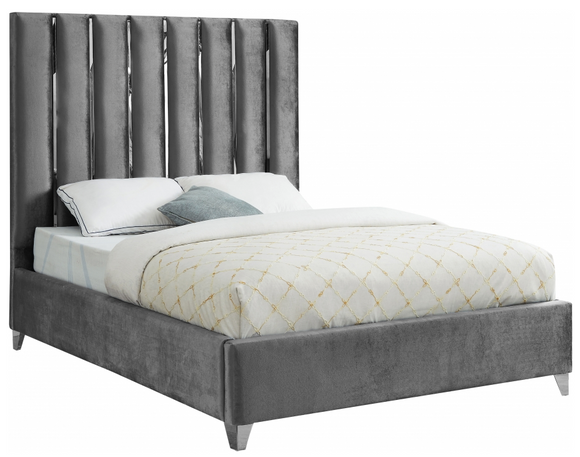 Create a bold yet welcoming sanctuary in your bedroom with this Roxx Velvet  Bed. The chrome channel design features velvet fabric upholstery for a sleek, glamorous look. The chrome legs provide support for the plank-style base, ensuring durability and long-lived beauty. Full slats are included, making setup easy and quick. No box spring is required with this bed, so you can use it with your choice of mattress.