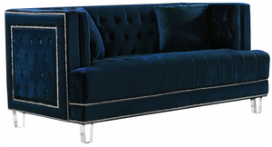 The Mauldin Modern Sofa Collection will take your home or office from ordinary to extraordinary. The nailhead trim, tufting, and acrylic legs come together to make the Mauldin collection a must have. This collection comes in four colors to better suit your design taste. Features beautifully tufted velvet upholstery with a custom nail head design and clear acrylic legs. This collection is guaranteed to be the highlight of any home.
