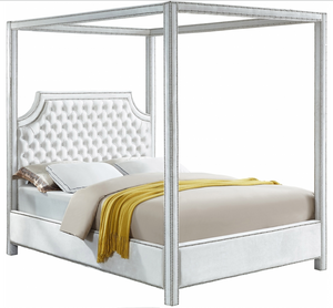 The Tailored Canopy Bed features a velvet-clad canopy that beckons you to rest like royalty. The deeply detailed tufting on the scalloped headboard makes for a sumptuous presentation, and the chrome nail heads add to the luxe look of this exquisite bed.