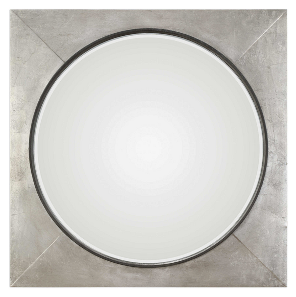 The Introvert Wall Mirror is modern and simple. Heavy iron frame finished in a hand applied metallic silver leaf, accented with a raised rustic black center. Mirror features a generous 1 1/4