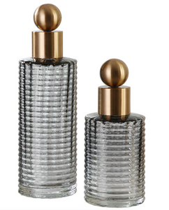 The Decador Decorative bottle set is a great additions to any modern space. Create a soothing display with these glass bottle's elegant ribbed design in light charcoal accented with sophisticated brushed brass tops. For decorative purposes only.