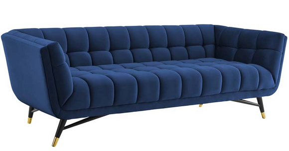 Embolden your living room décor with the Tipper Modern Sofa. Featuring a blend of chic, contemporary, and mid-century modern design, It's broad profile, deep seating, generous tufting, stain-resistant velvet polyester upholstery, flared armrests, and subtle metal accents imbue rich detail and chic sophistication